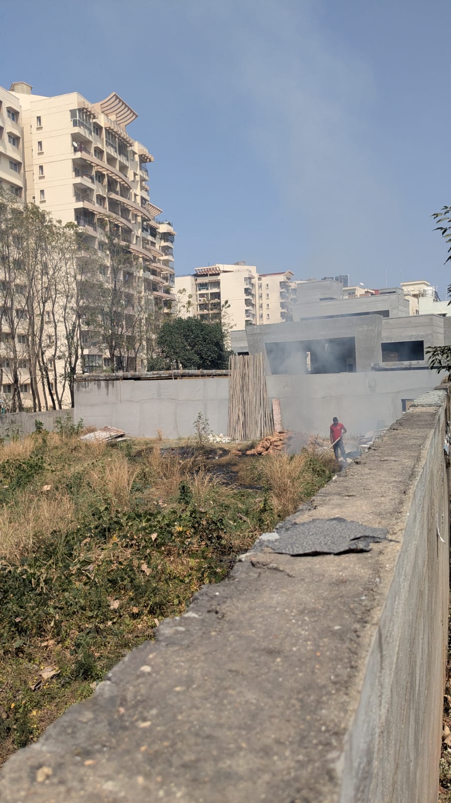 Person burning trash and stubble near Mantri Tranquil